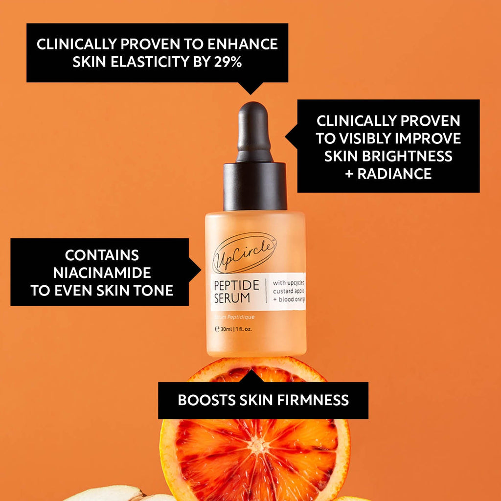 UpCircle Peptide Serum with Custard Apple and Blood Orange in a glass bottle, with a dropper and a skincare background