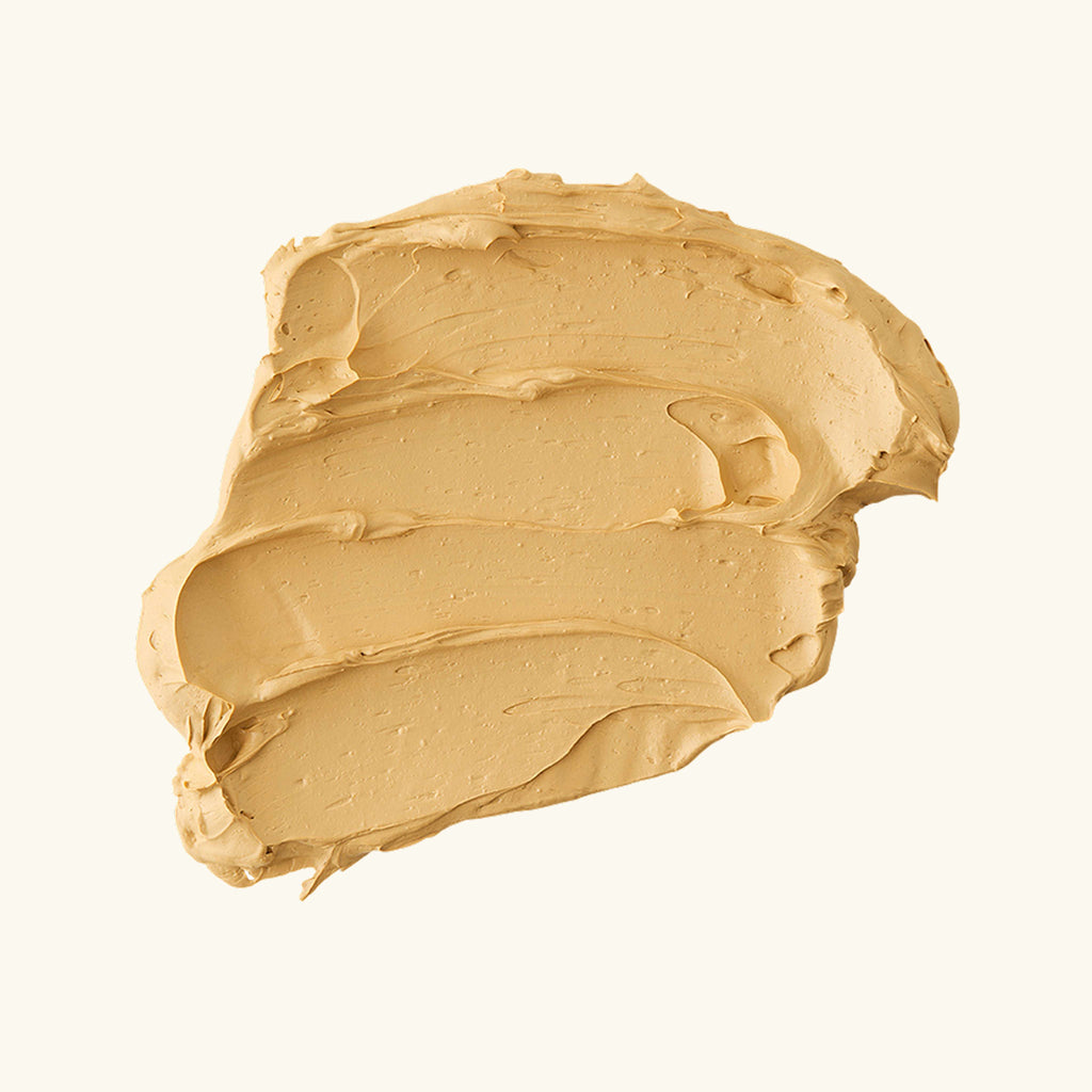 Vitamin C clay mask in jar with turmeric-toned formula, shown with Australian botanical ingredients on a clean white surface