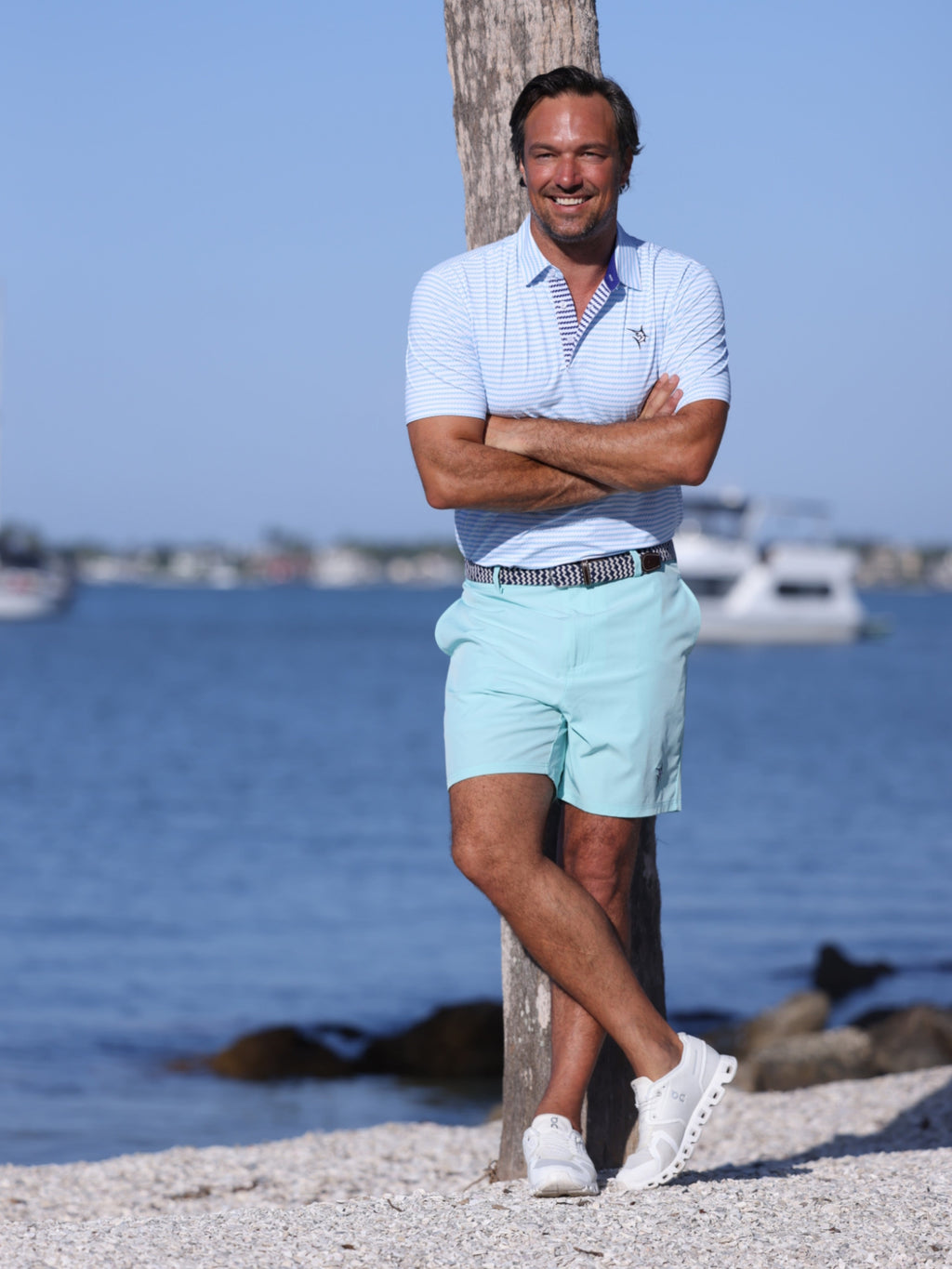 Aqua Freeport performance short laid flat, showing zippered back pocket and relaxed fit