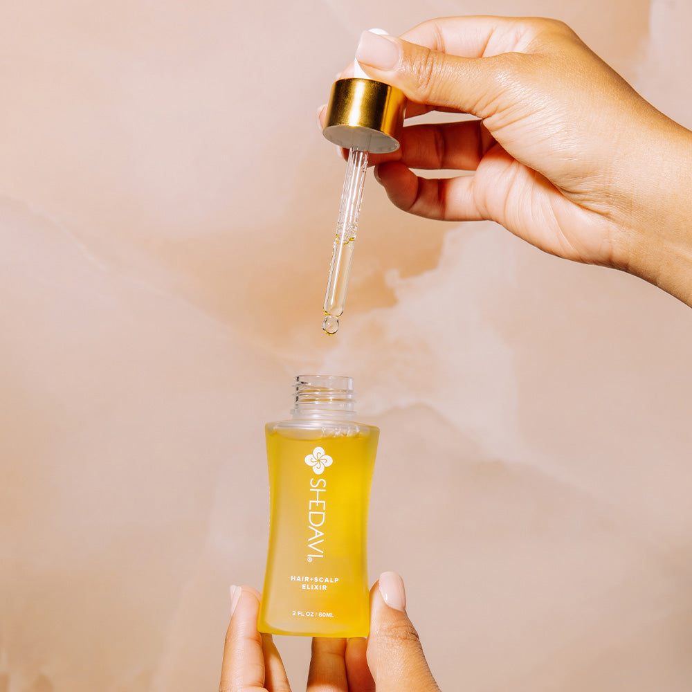 Shedavi Iconic Hair and Scalp Growth Elixir Oil bottle with natural oil ingredients including baobab, peppermint, and coconut