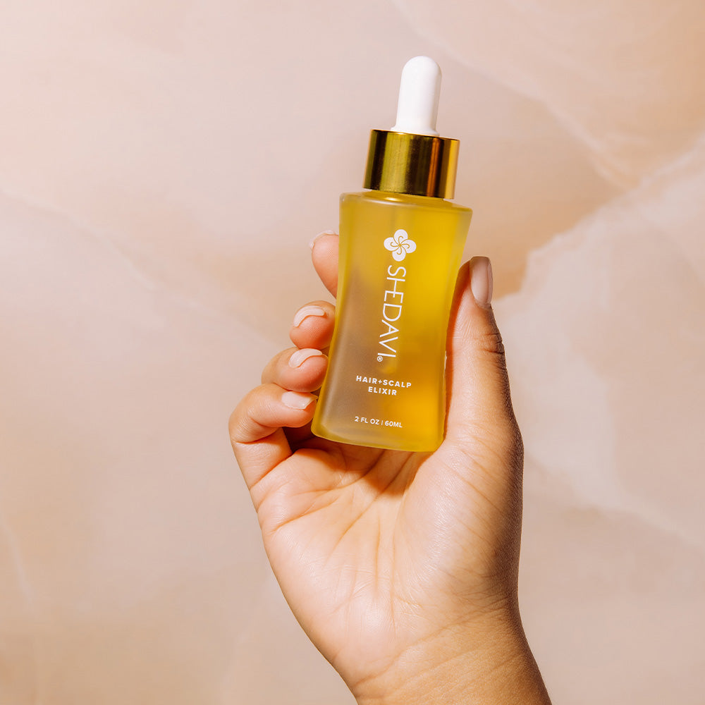Shedavi Iconic Hair and Scalp Growth Elixir Oil bottle with natural oil ingredients including baobab, peppermint, and coconut