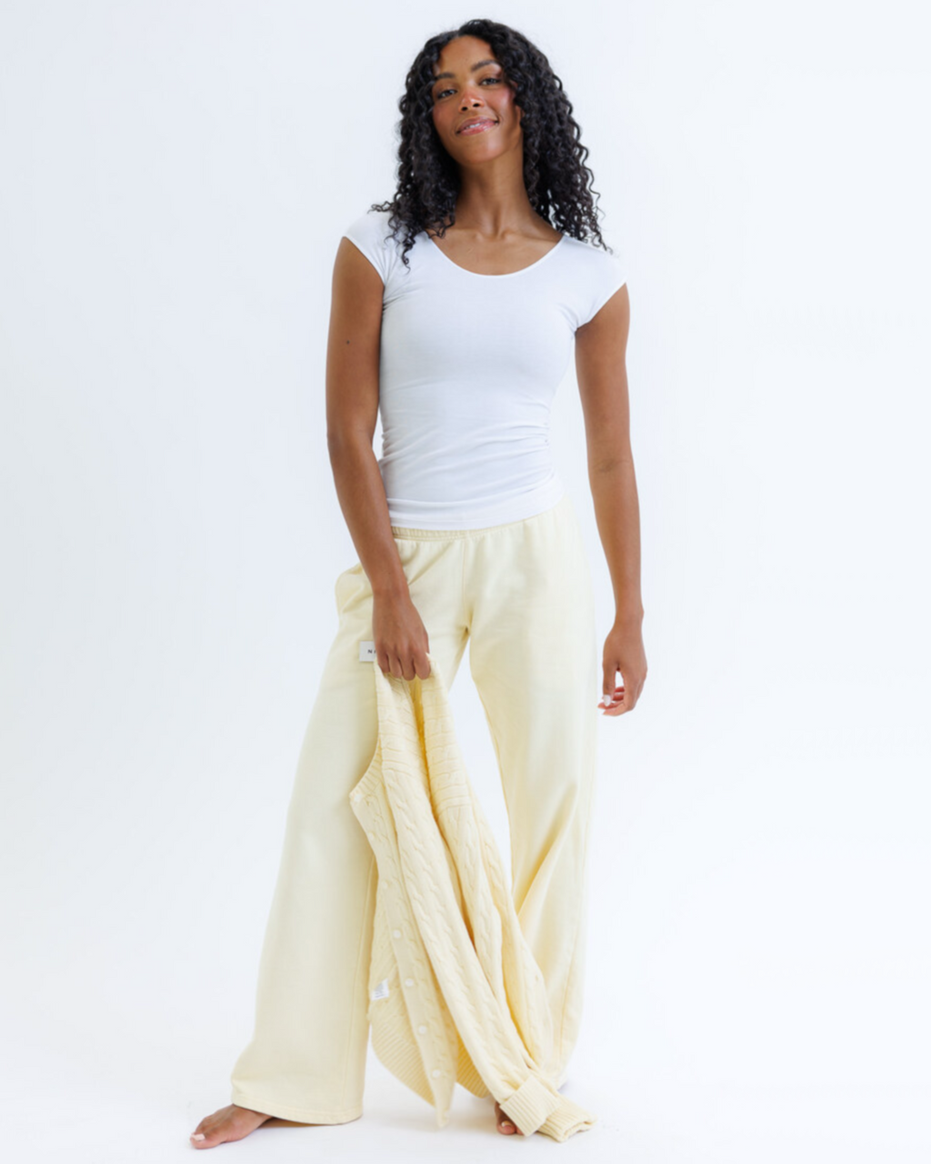 Women's fitted tri-blend essential tee with scoop neckline and cap sleeves, shown as a flat lay
