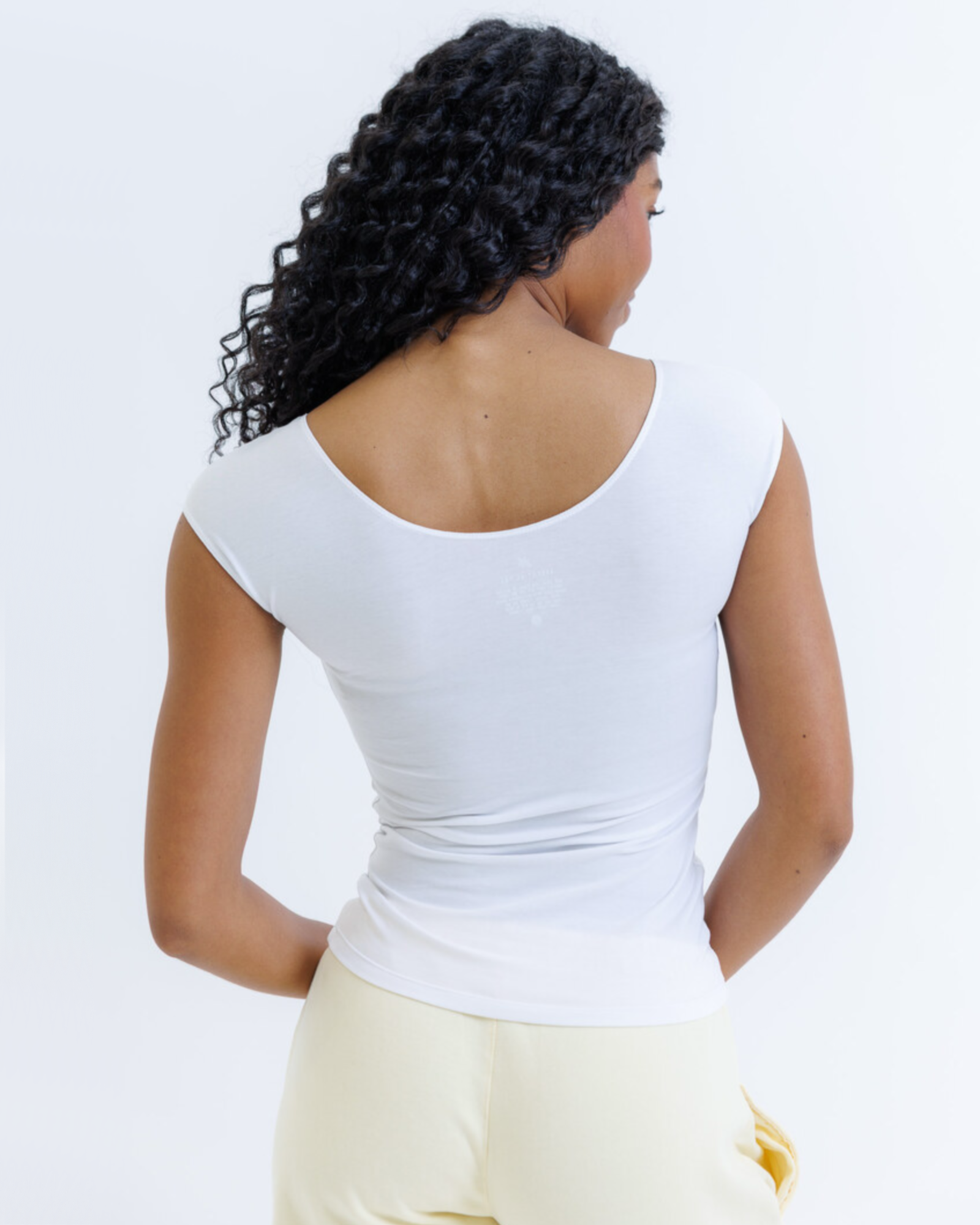 Women's fitted tri-blend essential tee with scoop neckline and cap sleeves, shown as a flat lay