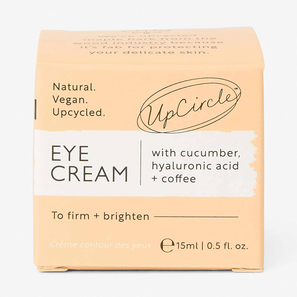 UpCircle eye cream in a glass jar with aluminium lid, showing coffee oil and hyaluronic acid formula for dark circles