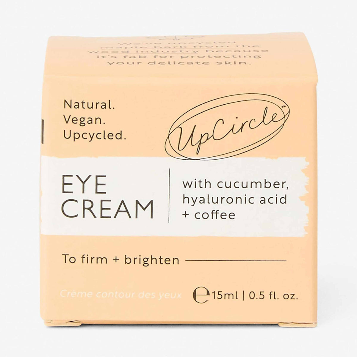 UpCircle eye cream in a glass jar with aluminium lid, showing coffee oil and hyaluronic acid formula for dark circles