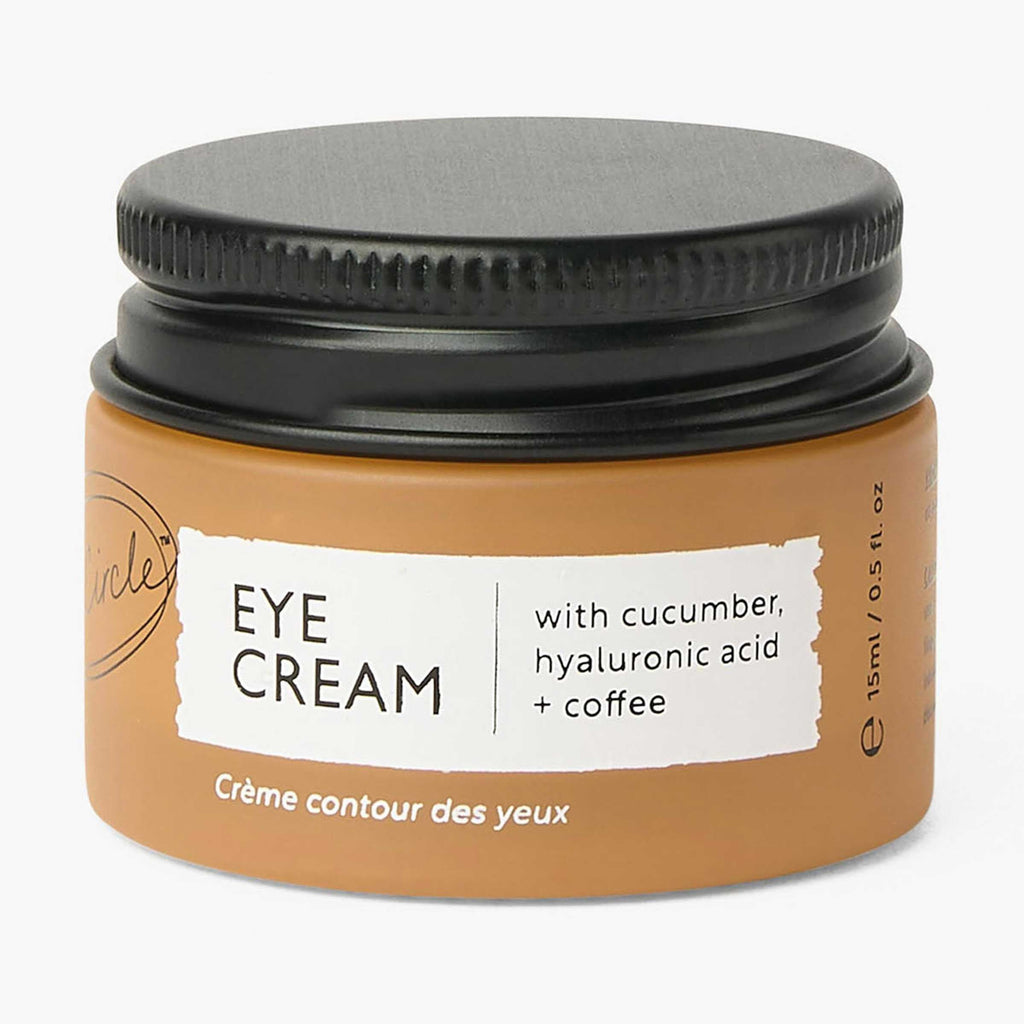 UpCircle eye cream in a glass jar with aluminium lid, showing coffee oil and hyaluronic acid formula for dark circles