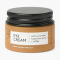 UpCircle eye cream in a glass jar with aluminium lid, showing coffee oil and hyaluronic acid formula for dark circles