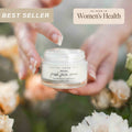 Small glass jar of tallow anti-aging face moisturizer with black lid on a clean surface