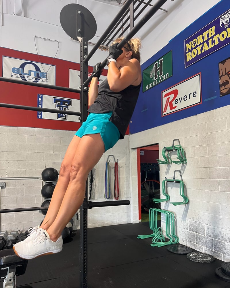 Women's Excel workout shorts in a relaxed training fit, showing extended hem length and waistband pocket detail