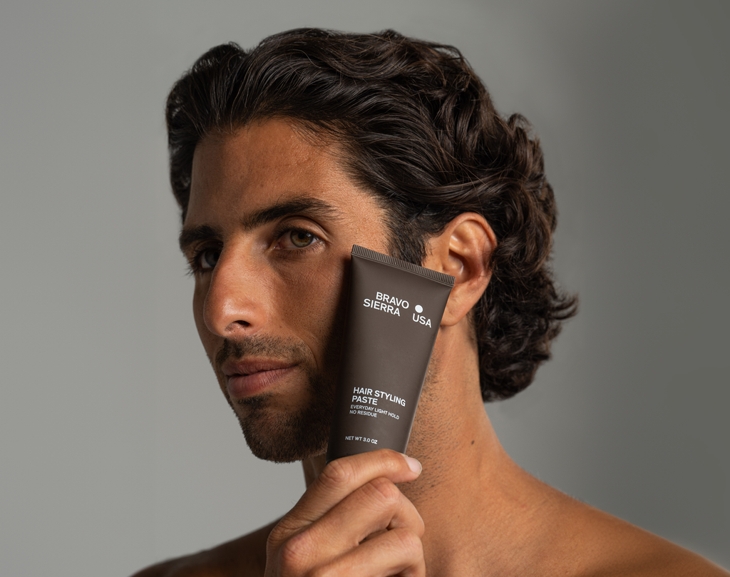 Close-up of hair styling paste jar with matte finish lid on a clean grooming surface