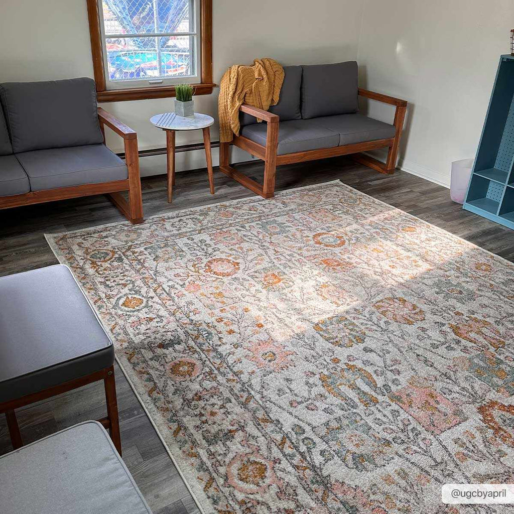 Herstmonceux traditional area rug with vintage pattern in charcoal, mustard, dusty pink, and off-white tones on a medium pile