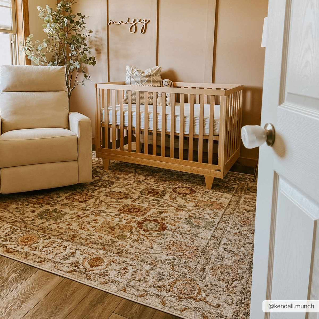 Herstmonceux traditional area rug with vintage pattern in charcoal, mustard, dusty pink, and off-white tones on a medium pile