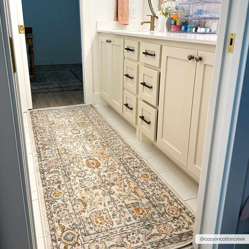 Herstmonceux traditional area rug with vintage pattern in charcoal, mustard, dusty pink, and off-white tones on a medium pile