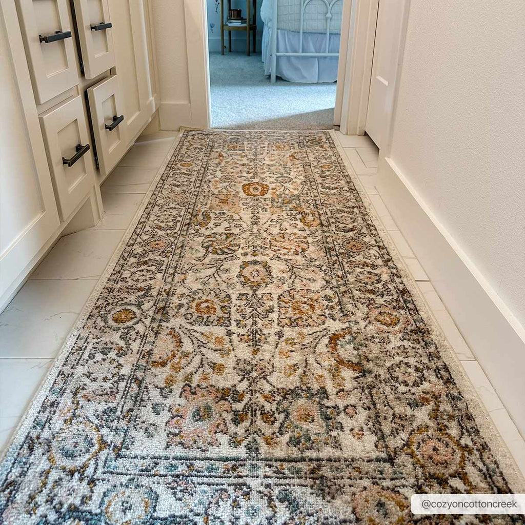 Herstmonceux traditional area rug with vintage pattern in charcoal, mustard, dusty pink, and off-white tones on a medium pile