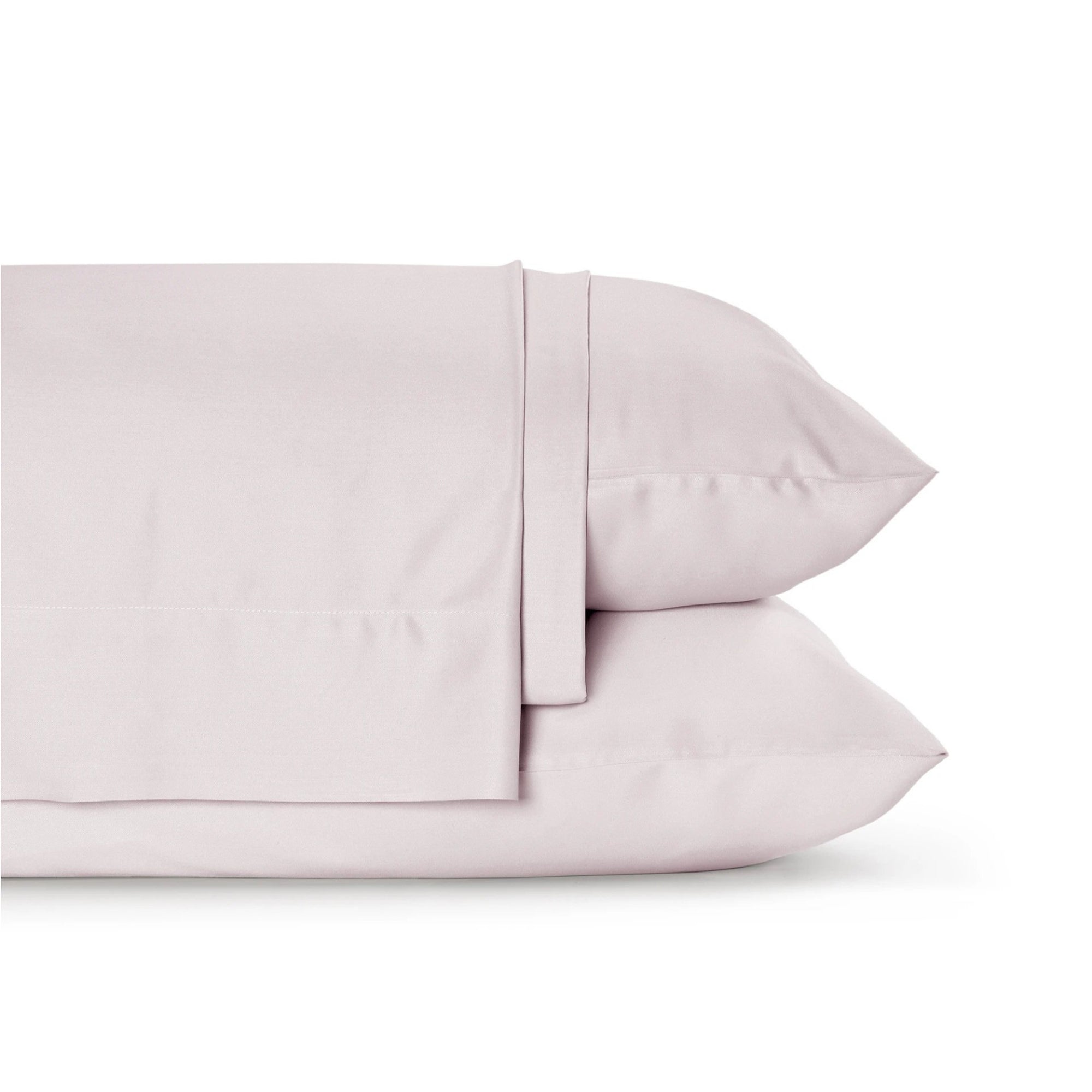 Four-piece bamboo viscose sheet set in neutral tone draped over a neatly made bed, showing silky smooth fabric texture