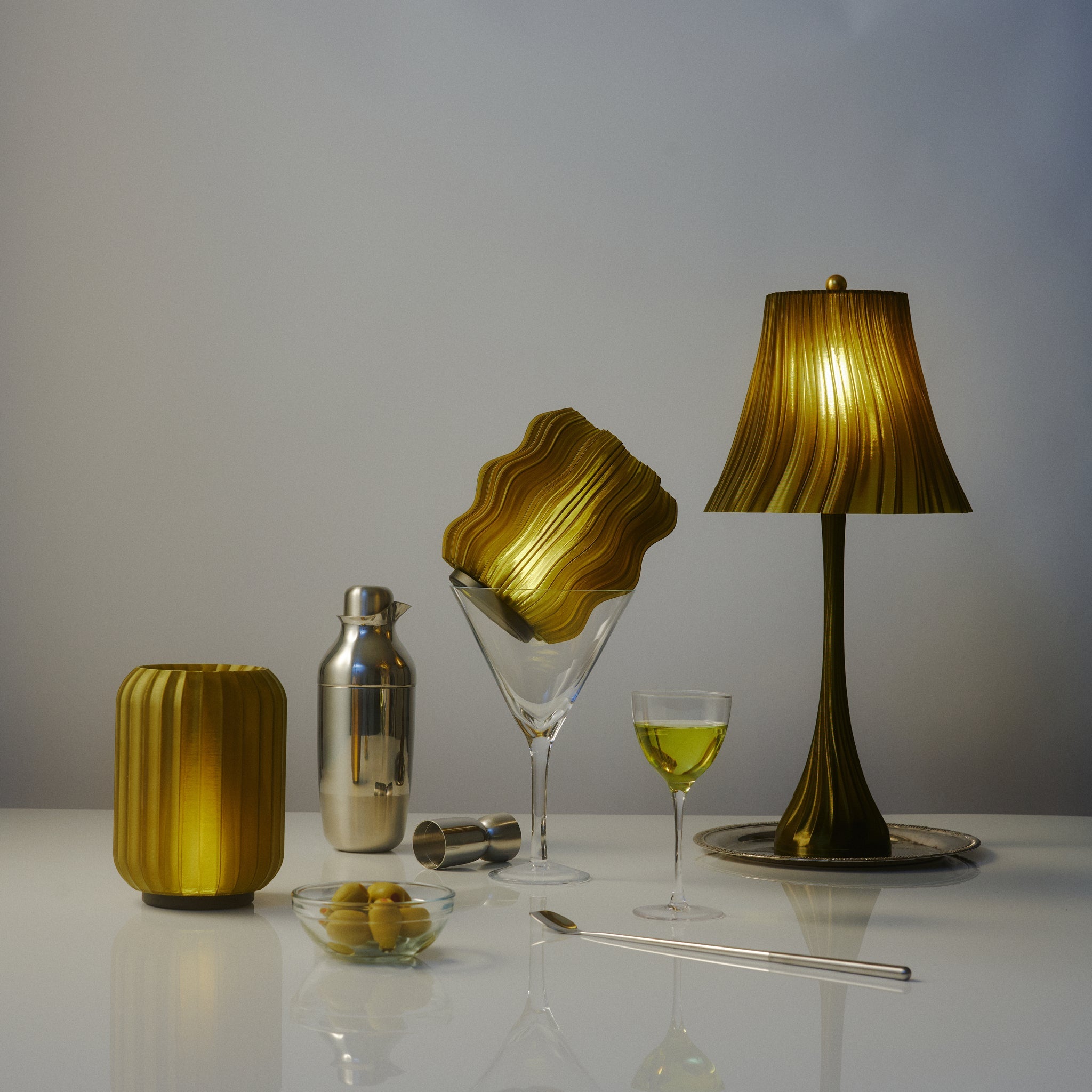 Cordless mini wavy sculptural table lamp with warm glowing filament on a nightstand