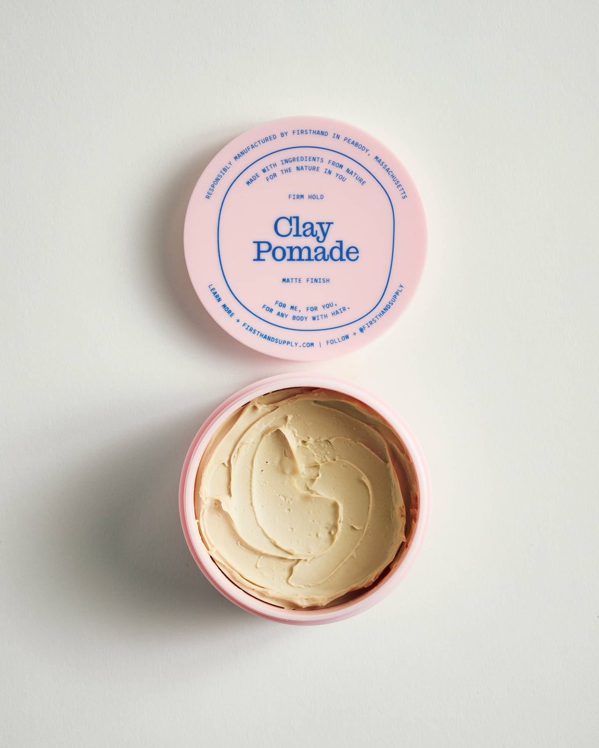 Firsthand Supply Clay Pomade 3 oz jar on a clean surface, matte finish lid with minimalist label