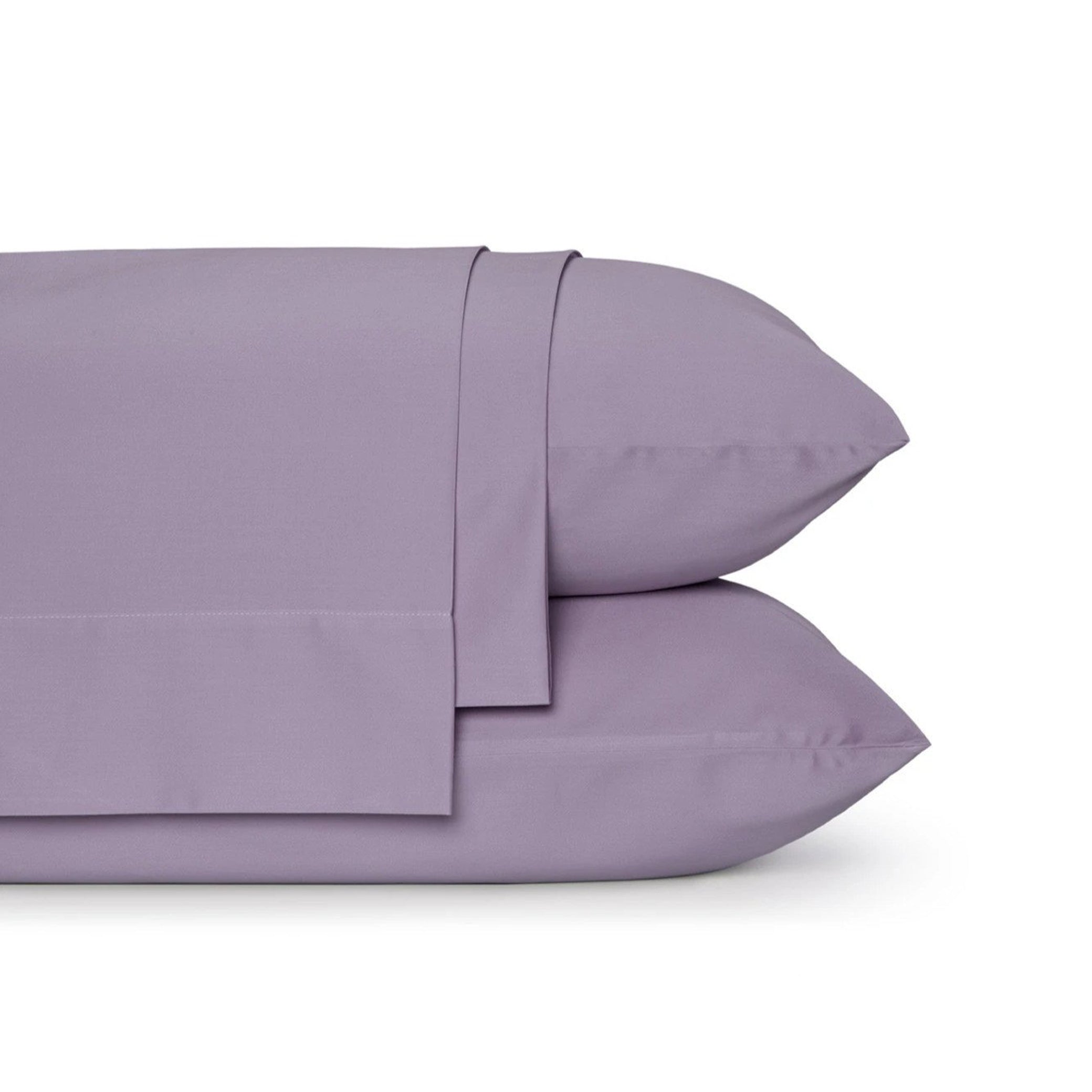 Four-piece bamboo viscose sheet set in neutral tone draped over a neatly made bed, showing silky smooth fabric texture