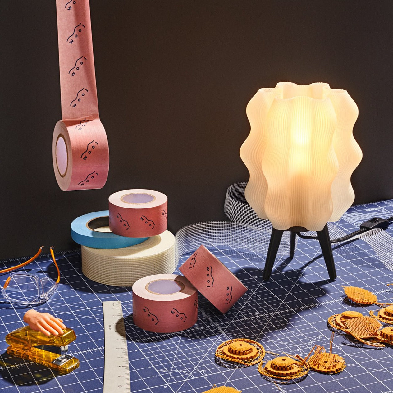 Wavy sculptural table lamp in recycled corn-based plastic with organic rippled silhouette on a flat surface