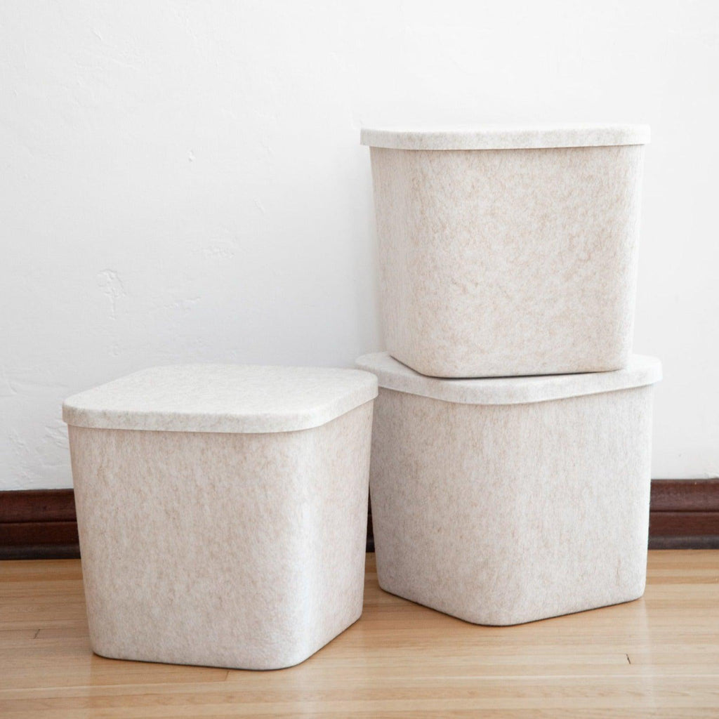SortJoy Sculpted Storage Bin in Carbon colorway, structured shape on a shelf holding folded linens
