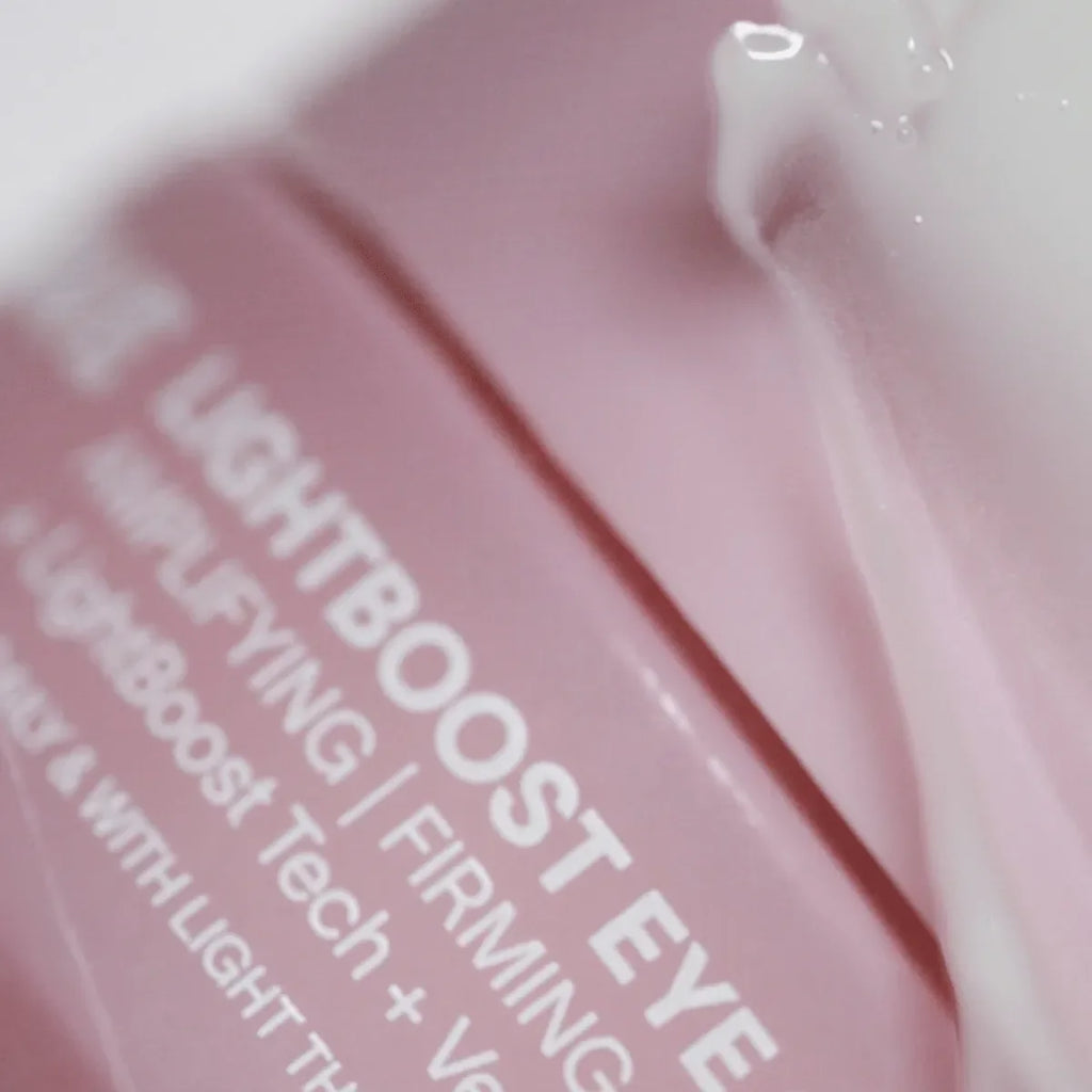 Solawave LightBoost Eye Cream tube on a clean surface, showcasing the silky cooling formula for dark circles and puffiness