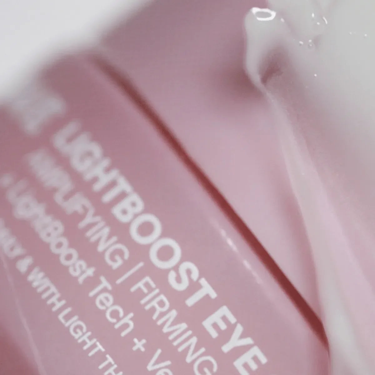 Solawave LightBoost Eye Cream tube on a clean surface, showcasing the silky cooling formula for dark circles and puffiness