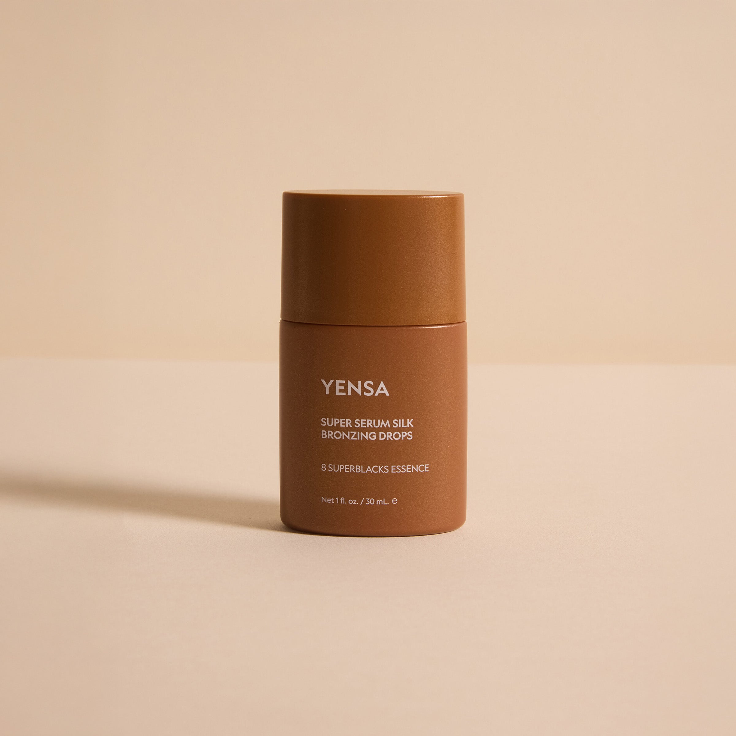 YENSA Super Serum Silk Bronzing Drops bottle with a swatch of sheer golden bronzing serum on skin