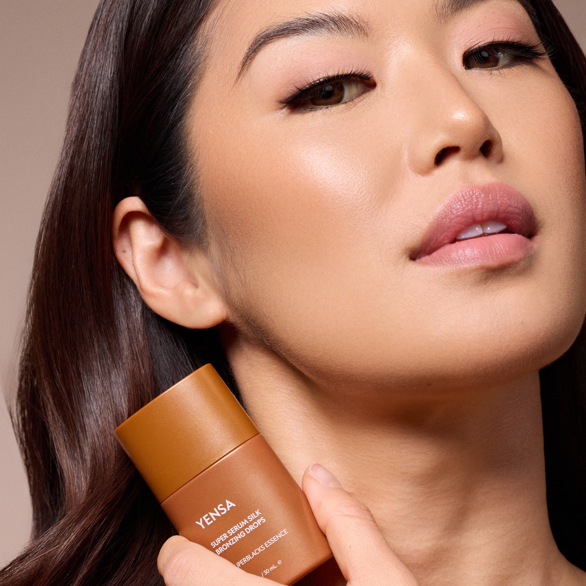 YENSA Super Serum Silk Bronzing Drops bottle with a swatch of sheer golden bronzing serum on skin