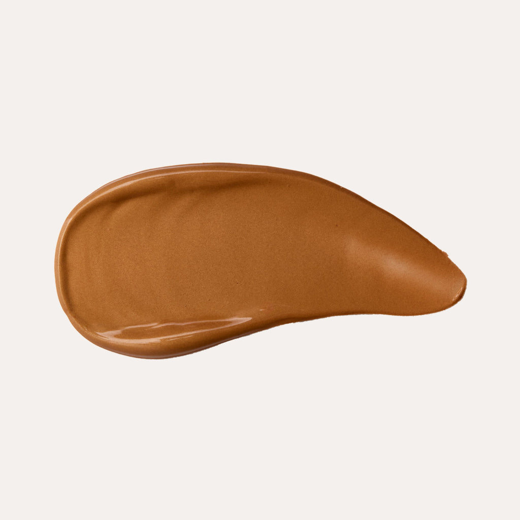 YENSA Super Serum Silk Bronzing Drops bottle with a swatch of sheer golden bronzing serum on skin
