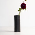 Ember Collective Bloom Vase, handmade white porcelain with a subtle oval rim, 8 inches tall, holding a small floral arrangement