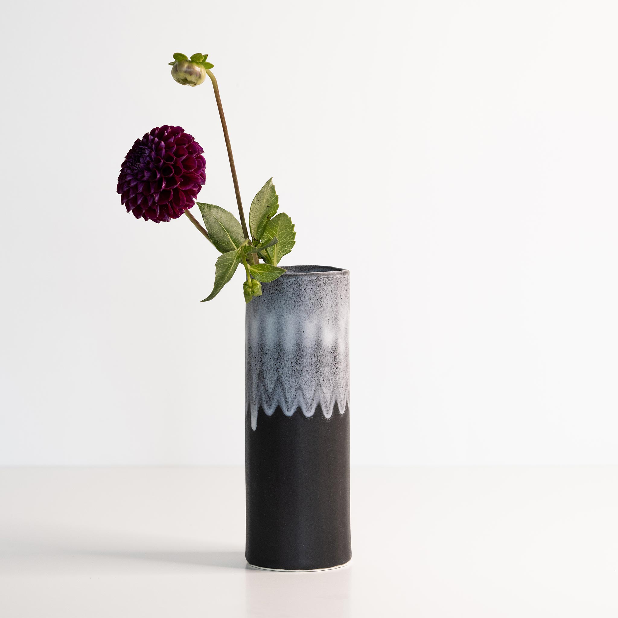 Ember Collective Bloom Vase, handmade white porcelain with a subtle oval rim, 8 inches tall, holding a small floral arrangement