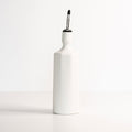 Elixir satin-glazed porcelain olive oil dispenser with drip-free pour spout on a kitchen countertop