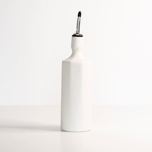 Elixir satin-glazed porcelain olive oil dispenser with drip-free pour spout on a kitchen countertop