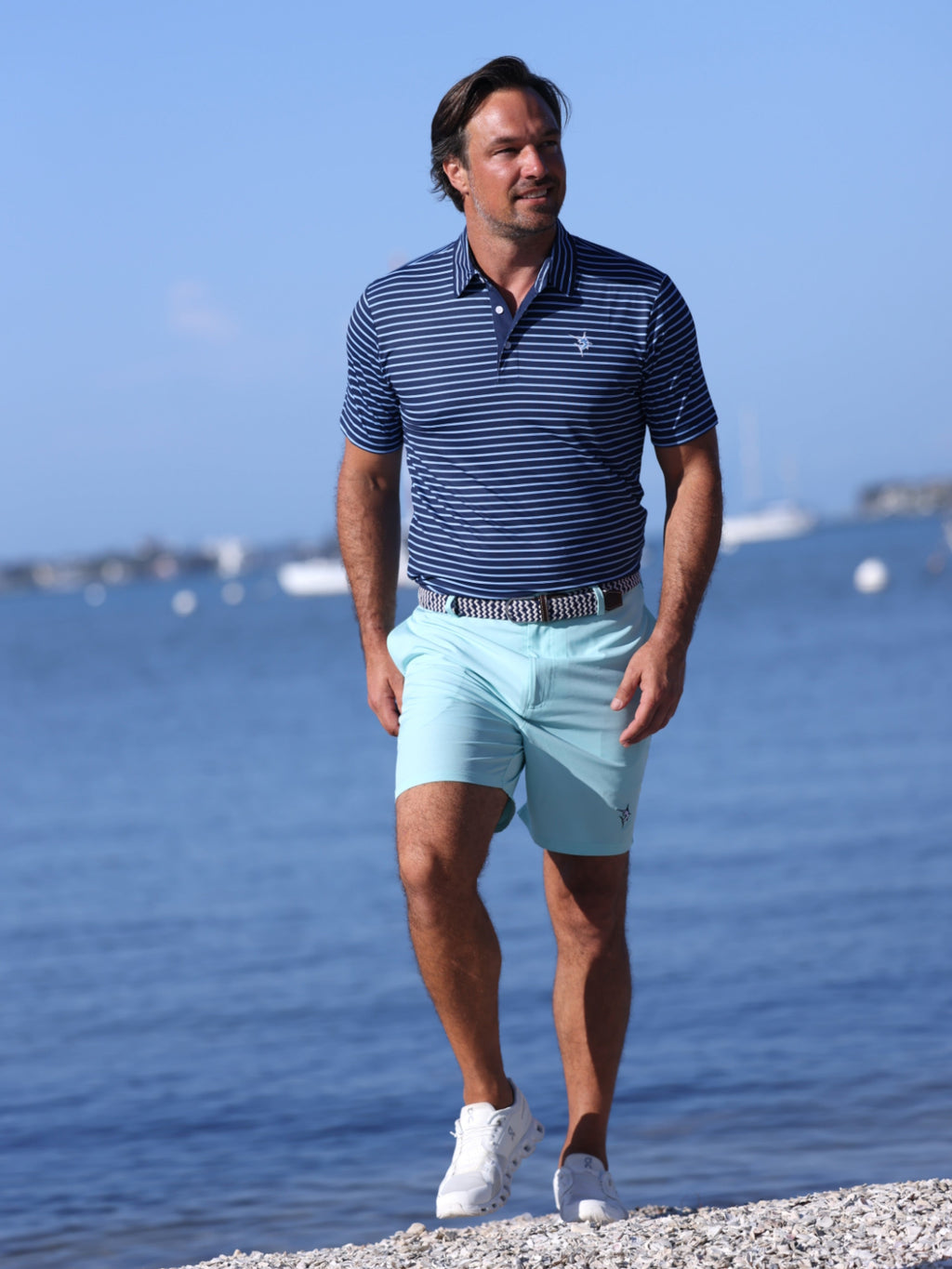 Aqua Freeport performance short laid flat, showing zippered back pocket and relaxed fit