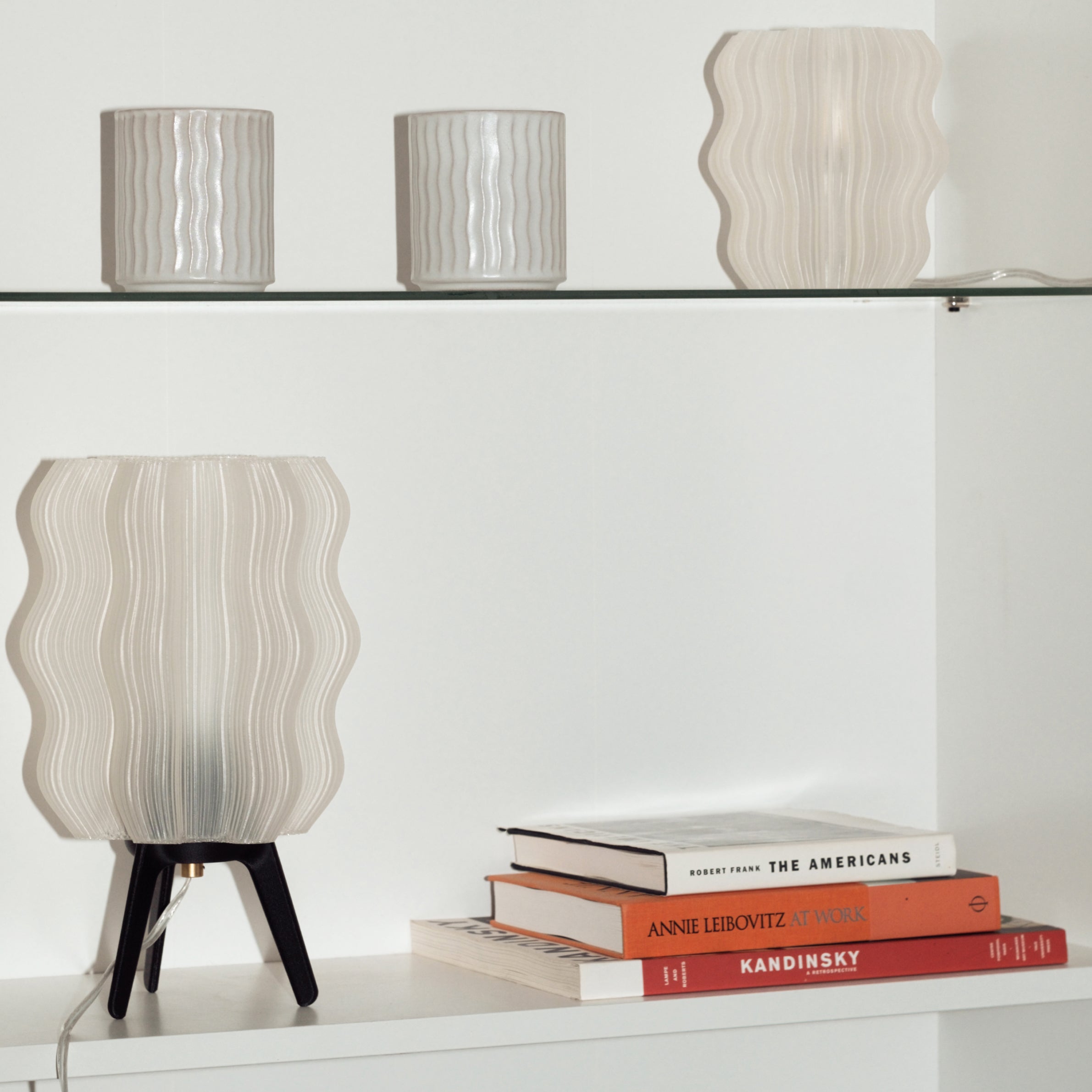 Wavy sculptural table lamp in recycled corn-based plastic with organic rippled silhouette on a flat surface