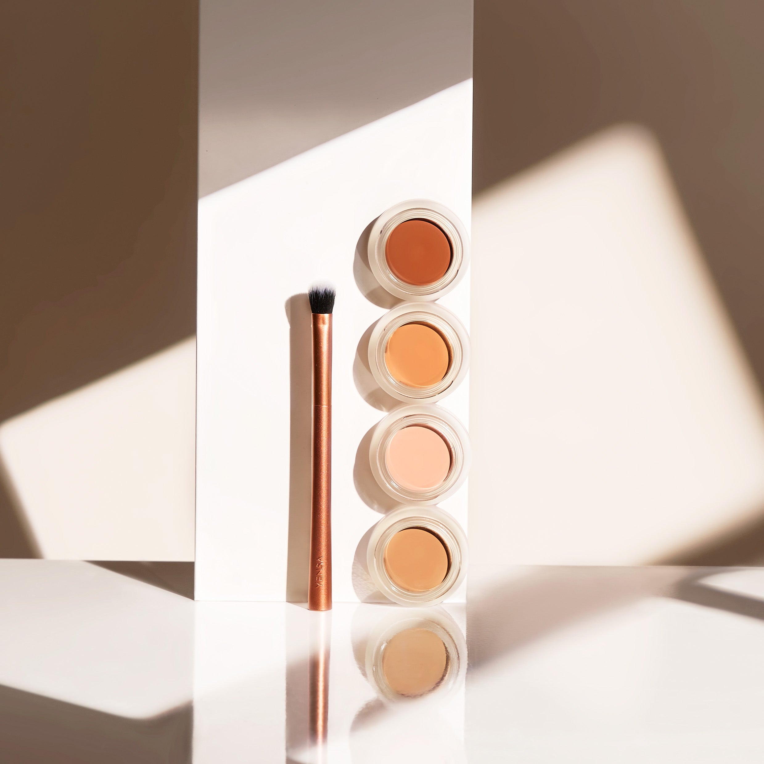 YENSA Super Bright Dark Circle Serum Peptide Corrector tube and applicator on a clean white surface
