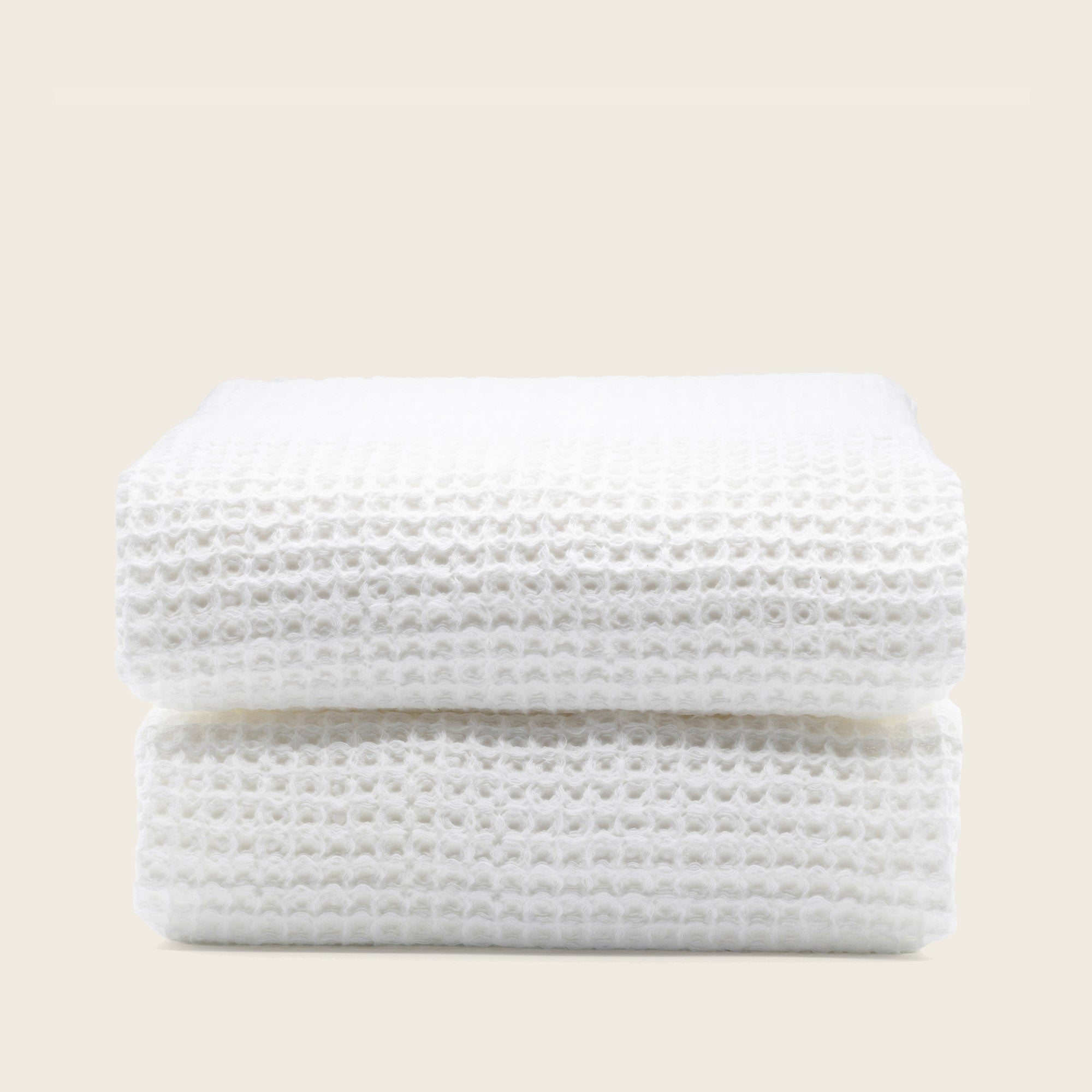 Folded Sedona Australian cotton waffle towels in a neutral colorway, showing dimensional open-weave texture