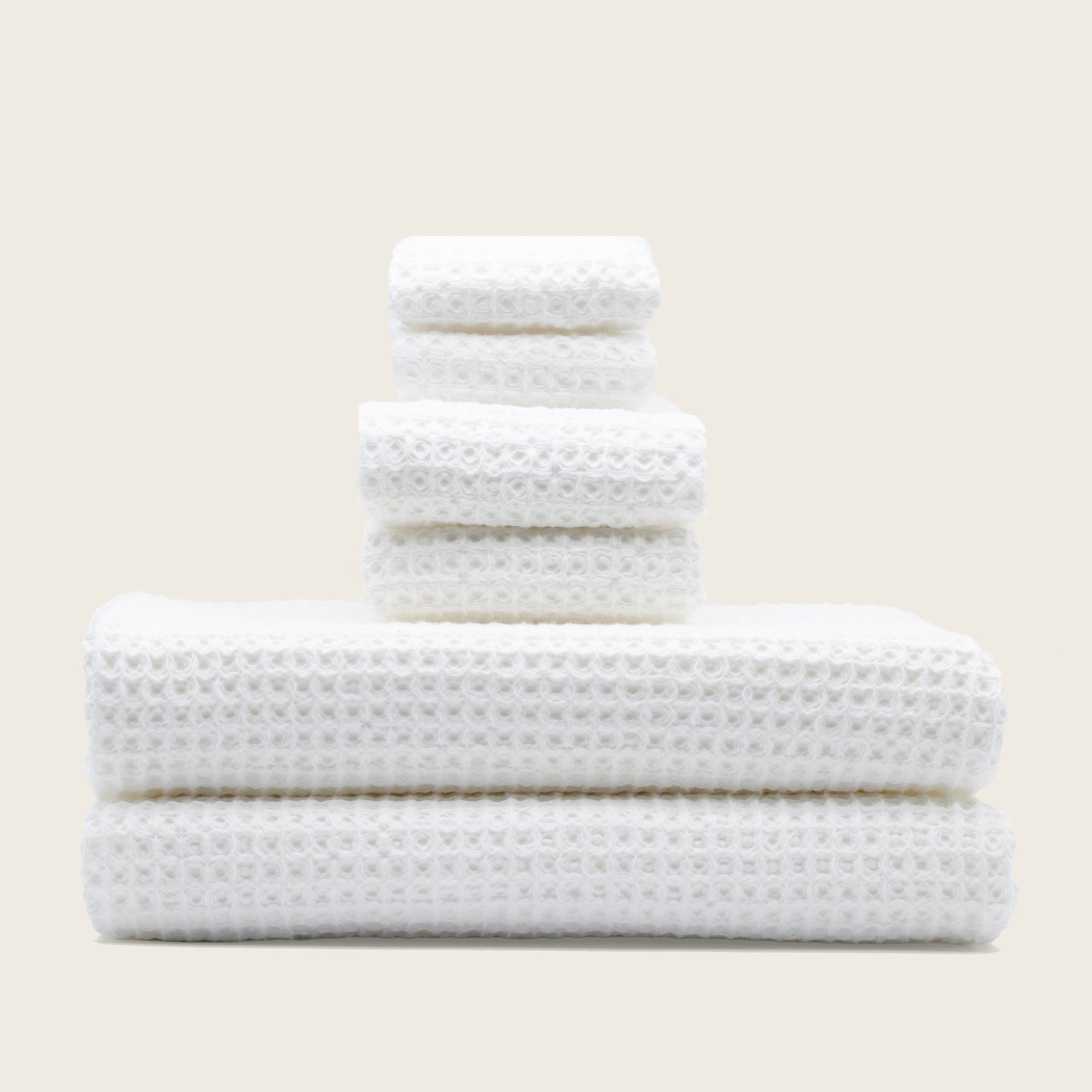 Folded Sedona Australian cotton waffle towels in a neutral colorway, showing dimensional open-weave texture