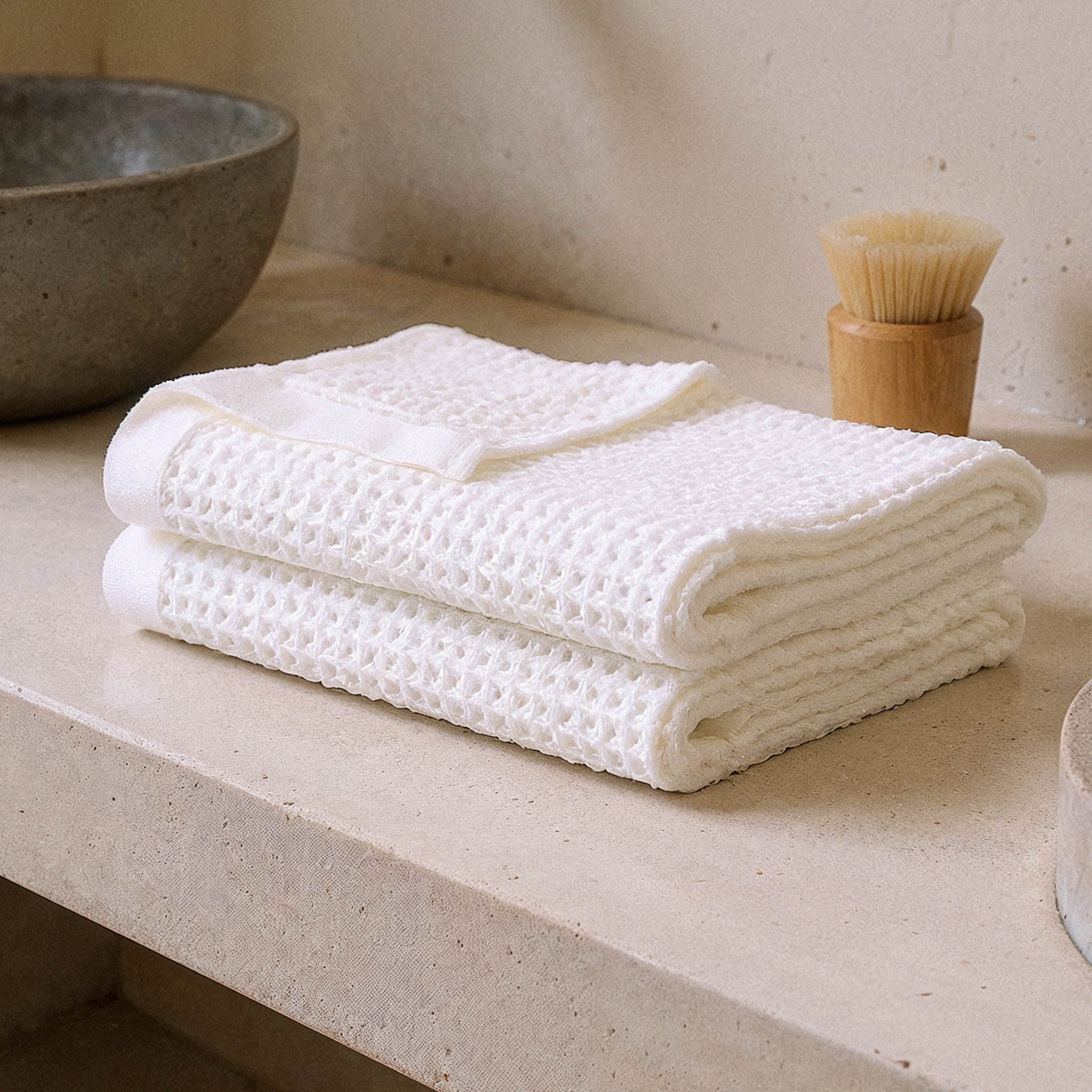 Folded Sedona Australian cotton waffle towels in a neutral colorway, showing dimensional open-weave texture