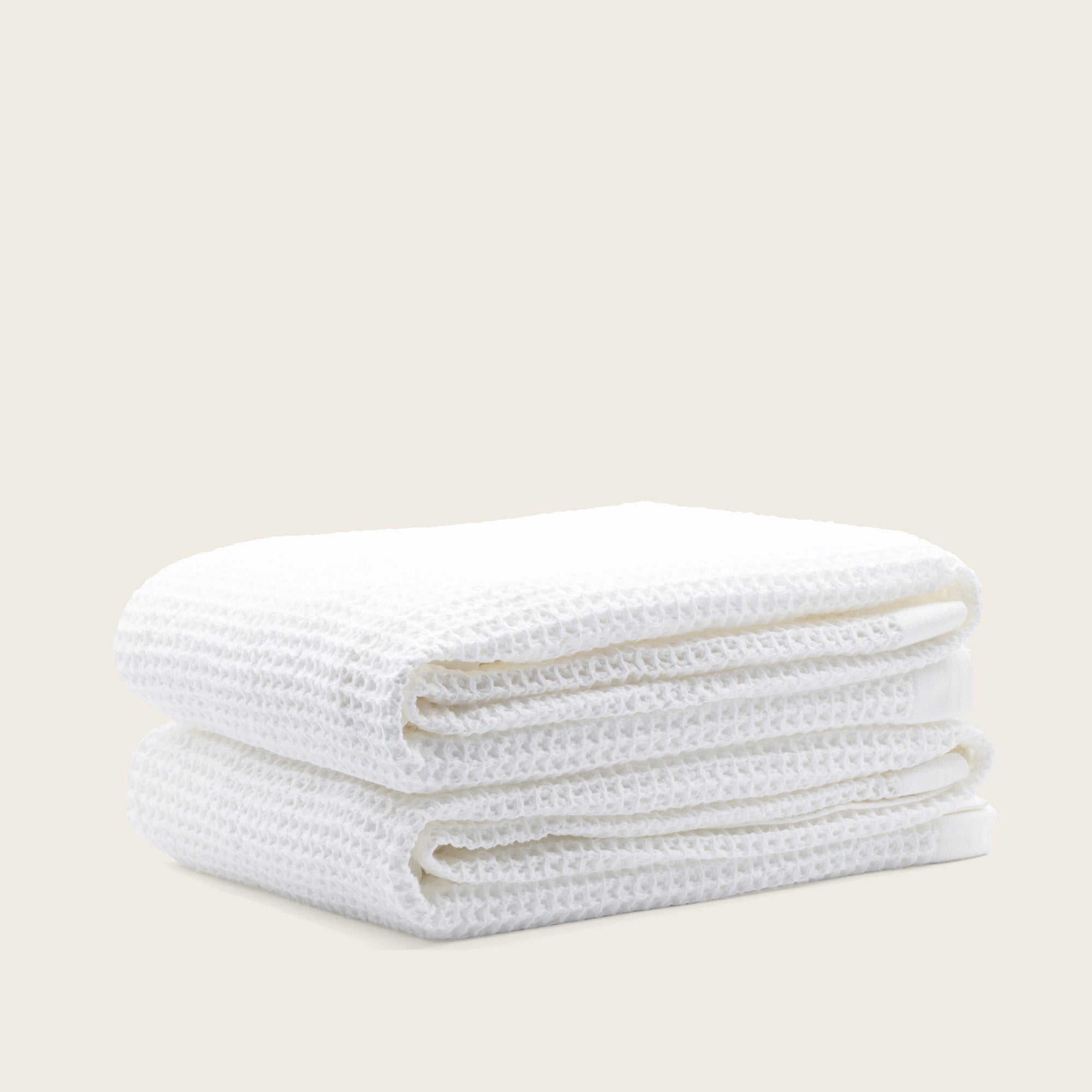 Folded Sedona Australian cotton waffle towels in a neutral colorway, showing dimensional open-weave texture