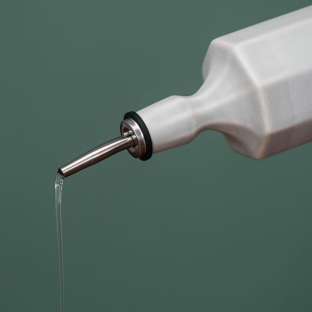 Elixir satin-glazed porcelain olive oil dispenser with drip-free pour spout on a kitchen countertop