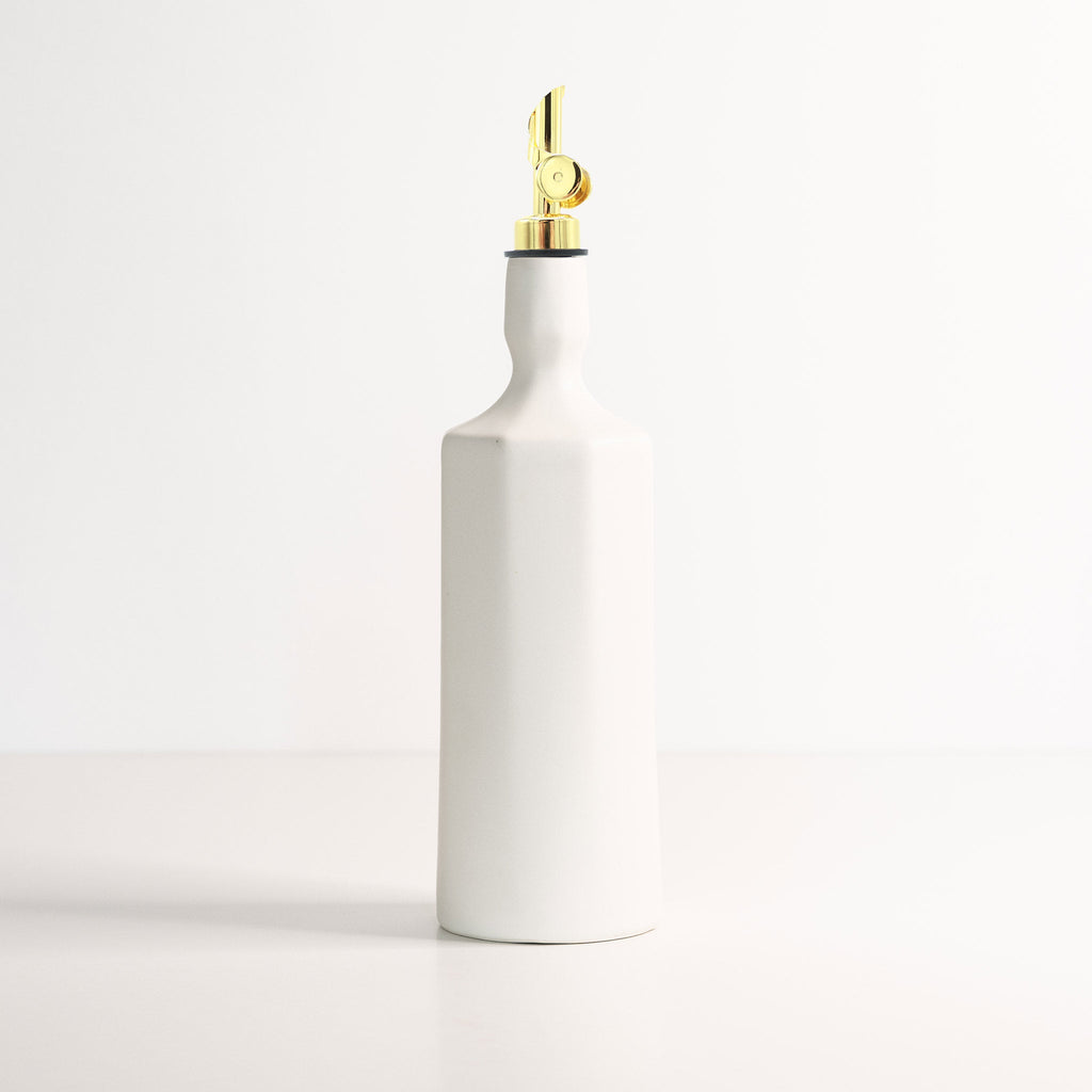 Elixir satin-glazed porcelain olive oil dispenser with drip-free pour spout on a kitchen countertop