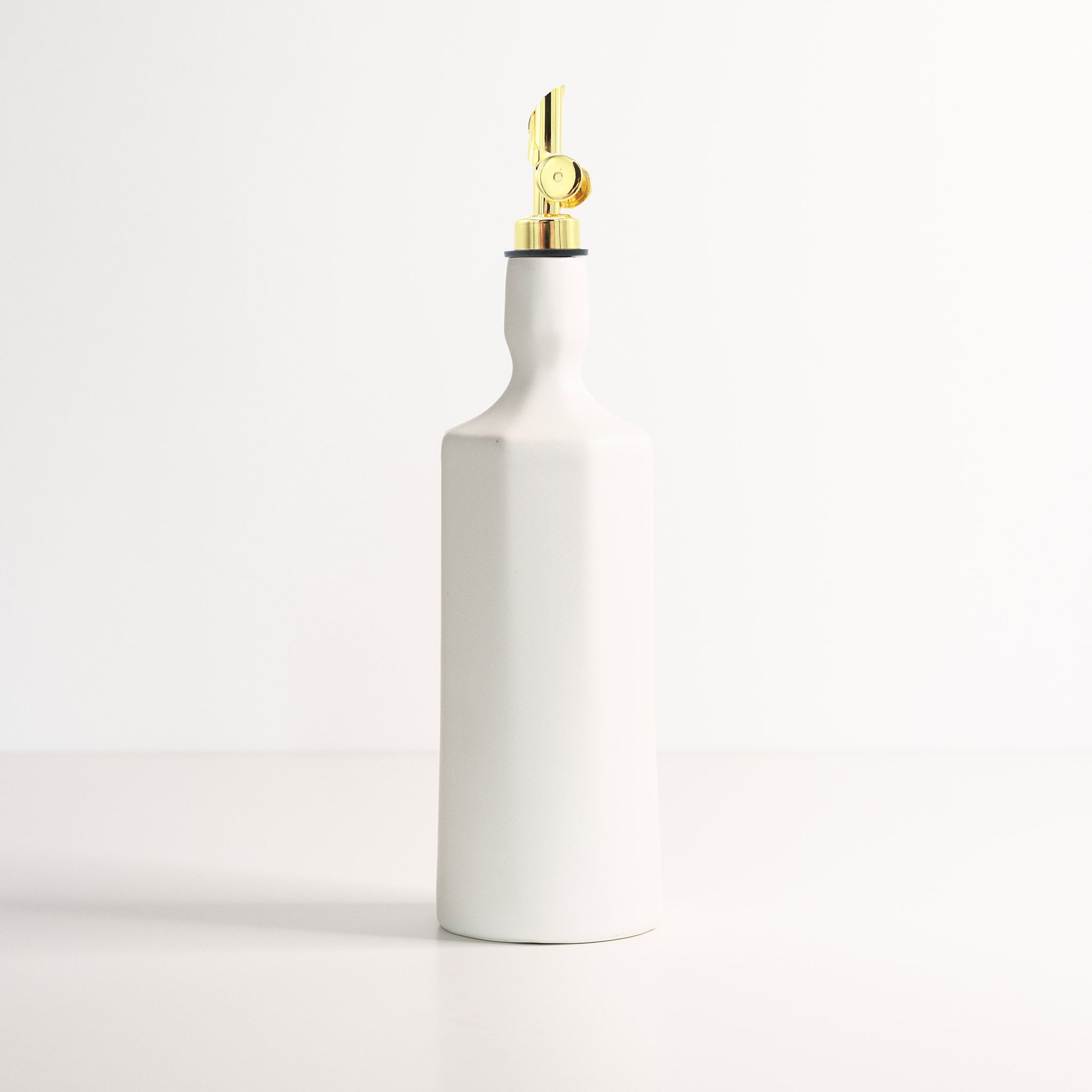 Elixir satin-glazed porcelain olive oil dispenser with drip-free pour spout on a kitchen countertop