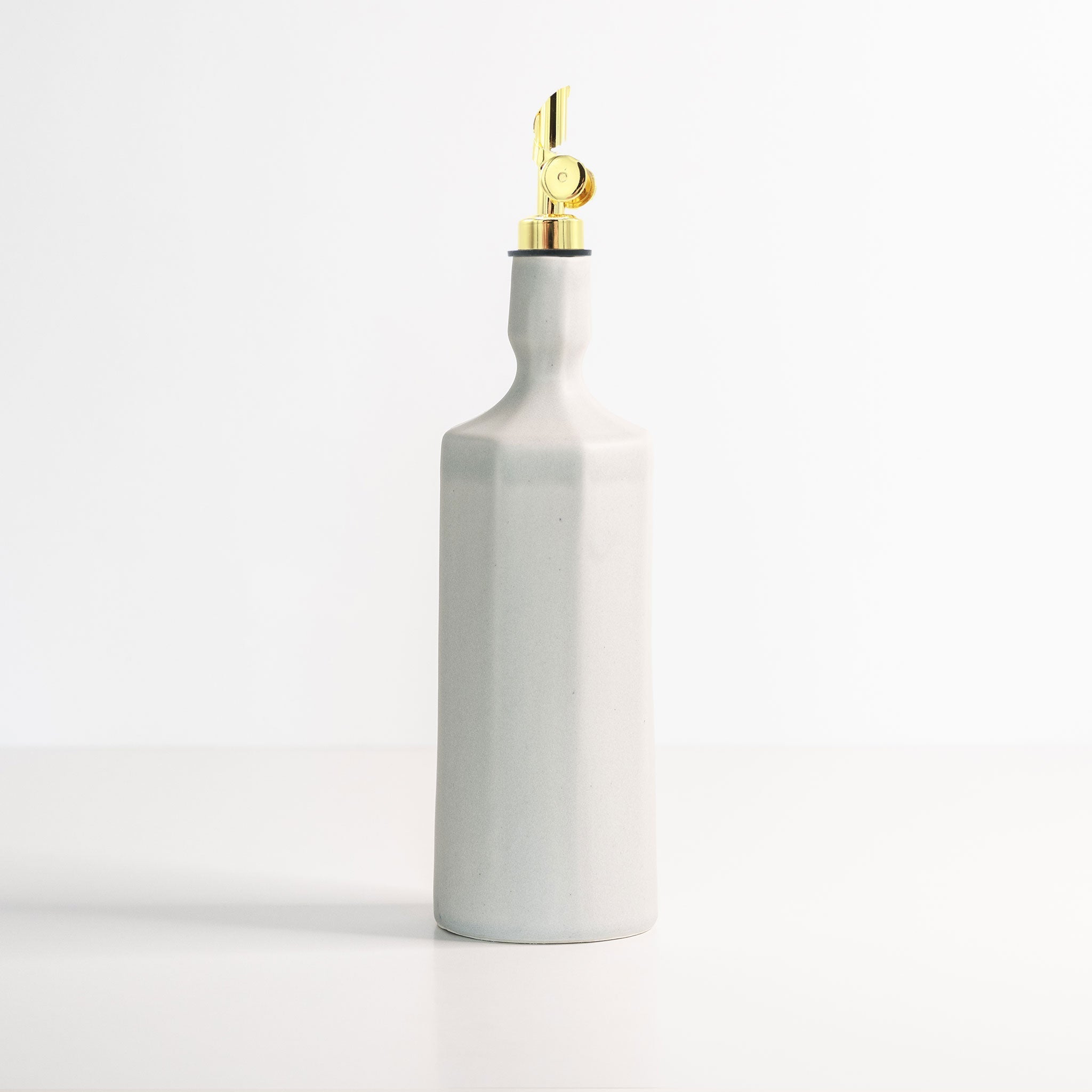 Elixir satin-glazed porcelain olive oil dispenser with drip-free pour spout on a kitchen countertop