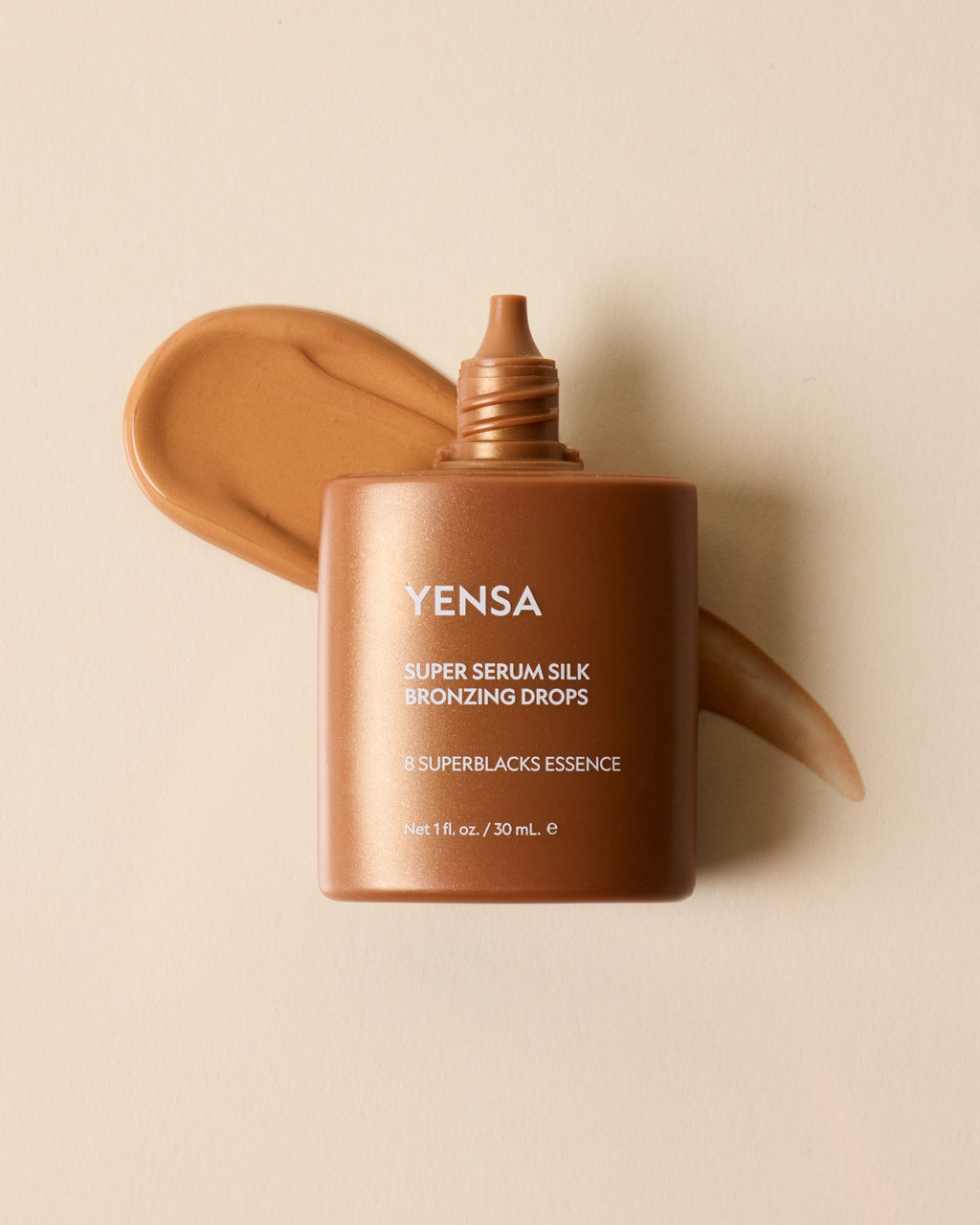 YENSA Super Serum Silk Bronzing Drops bottle with a swatch of sheer golden bronzing serum on skin