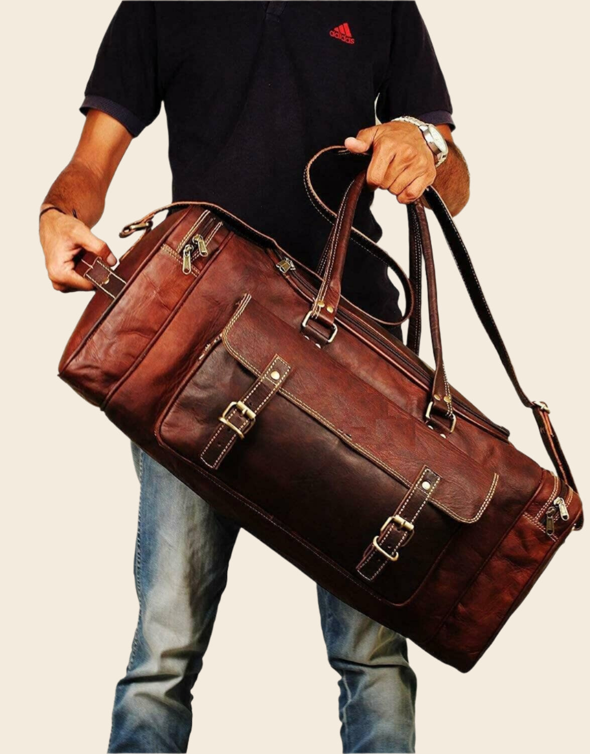 Vintage brown full-grain goat leather weekender duffle bag with brass hardware and matching toiletry bag on neutral background