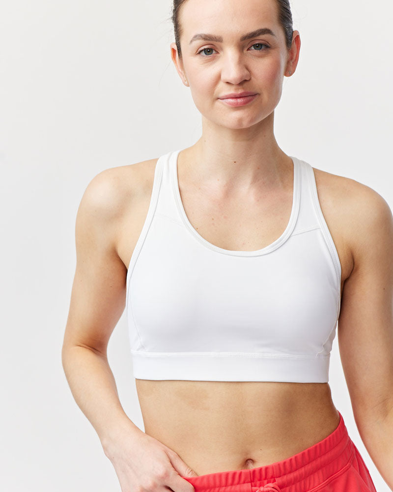 Front view of the 99'er padded sports bra in a solid colorway showing the crossover hexagonal back detail and sleek silhouette