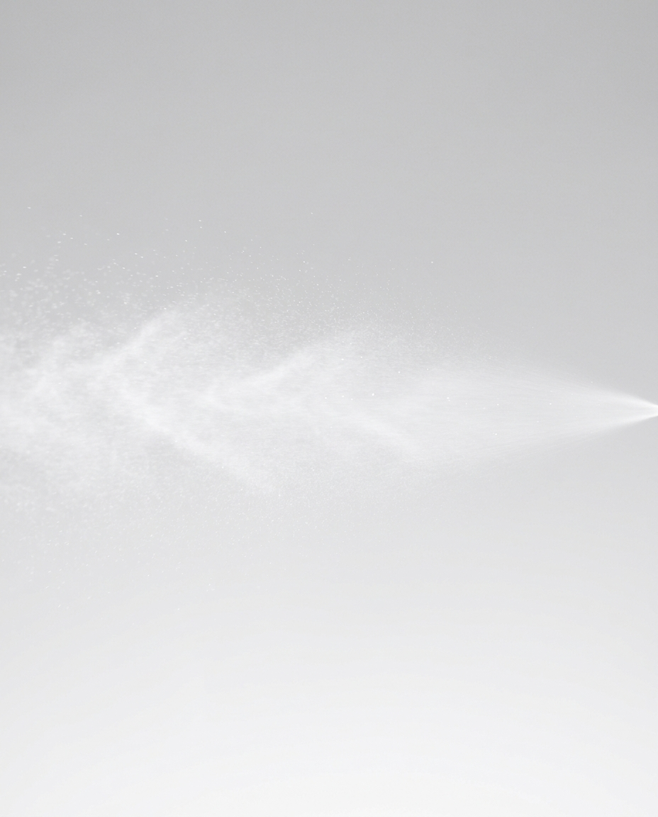 Sol Labs Ecomist Sheer Spray Mineral SPF 50 Face + Body Continuous Mist in a clear plastic bottle with a fine misting nozzle