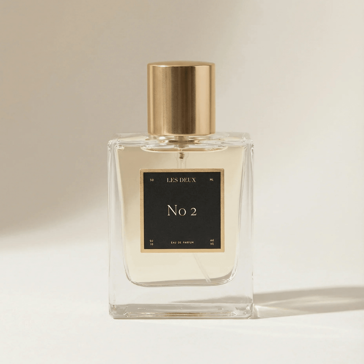 Les Deux Fragrances No. 2 Peau d'Or perfume bottle with amber and gold tones on a neutral background