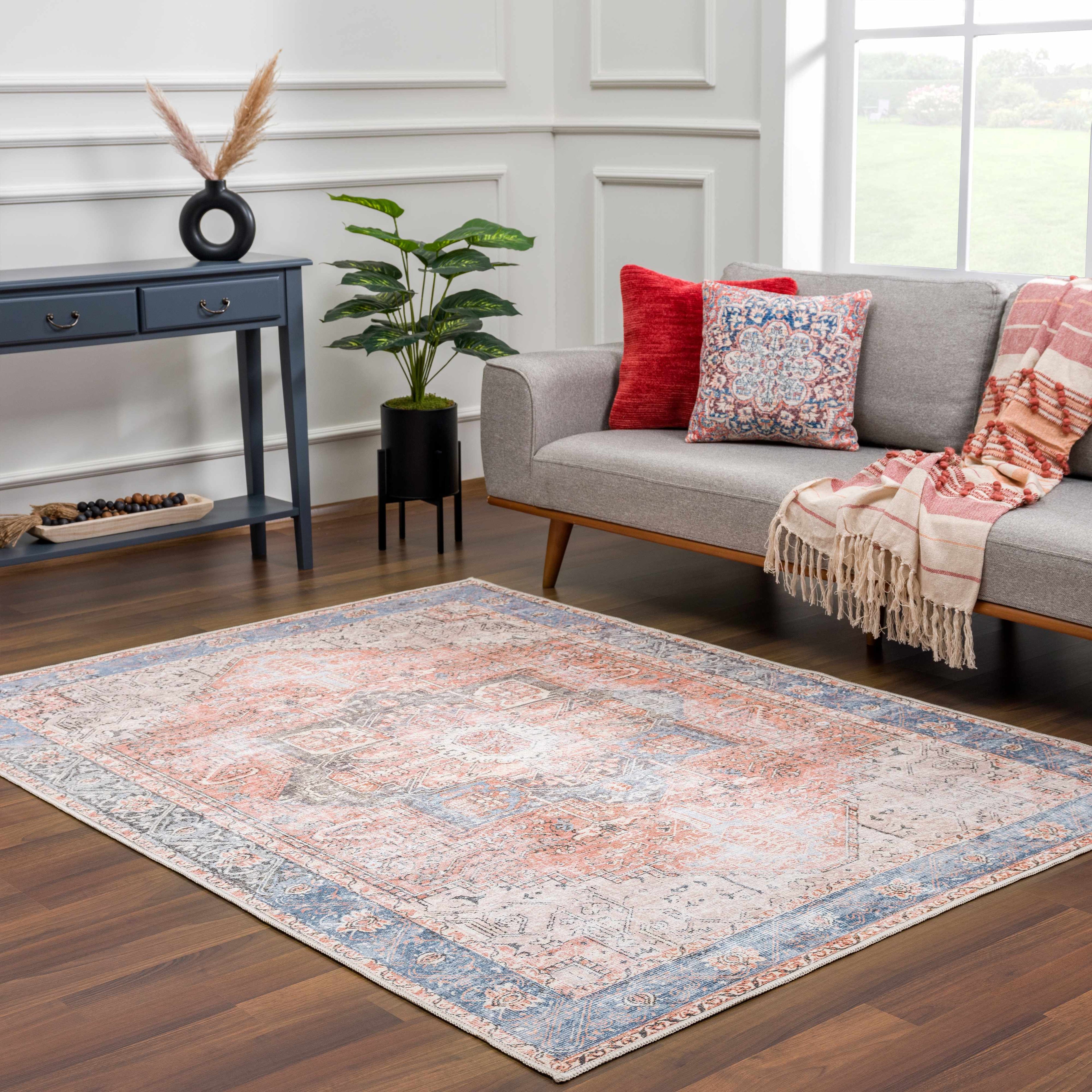 Rosman distressed flat weave area rug in warm red, blue, and earthy tones with vintage-inspired pattern